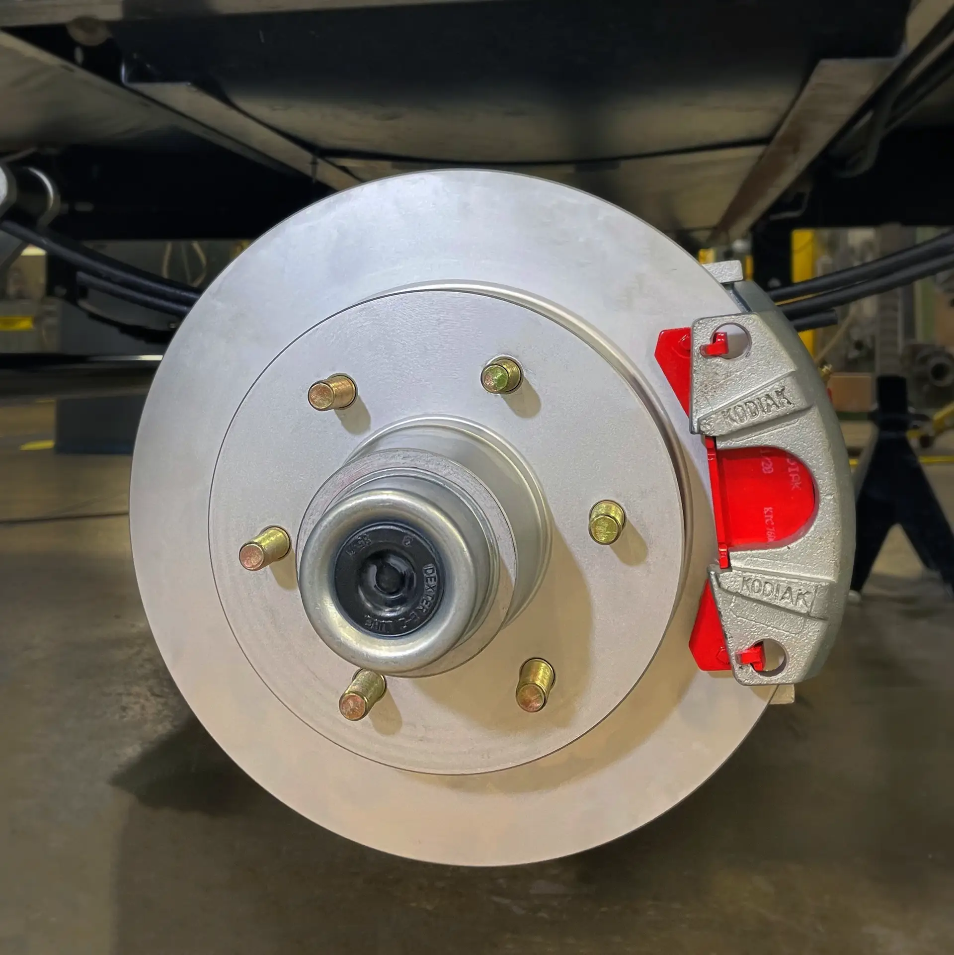 Close-up of Kodiak disc brake rotor and caliper mounted on RV axle.